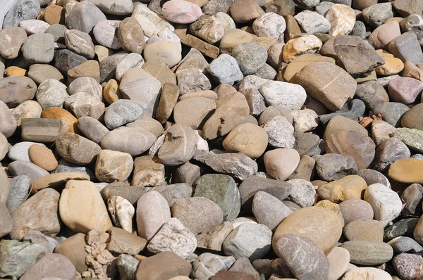 Large pebbles in sunshine lying on floor — Stock Photo, Image