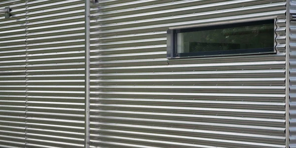 Facade of a building covered with corrugated iron — Stock Photo, Image