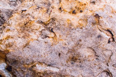 Resmin tamamındaki parlak renkler taşın yüzeyinin yapısını yansıtmıyor. Doku arka planı fikri. Doğal kayalar yakın çekim yapar..