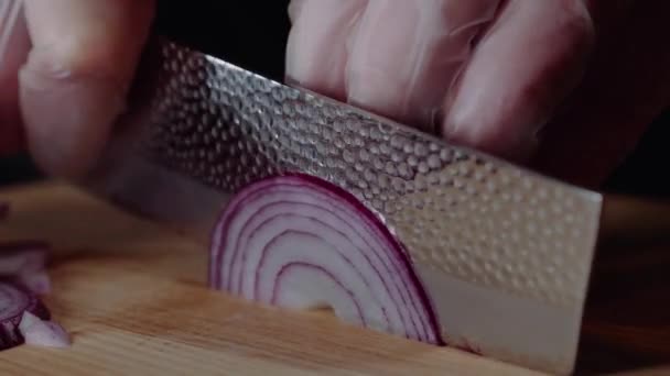 Chef making burger. Man slices the onion. Quick cutting of vegetables. Half rings of onions. bow for frying. The hands of the cook. Cut vegetables for hamburger or salad. Close-up. Macro — Stock Video