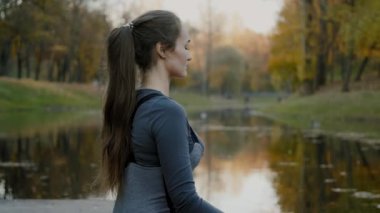 Genç kadın pratik yoga açık havada. Kadın meditasyon açık güzel sonbahar doğa infront.