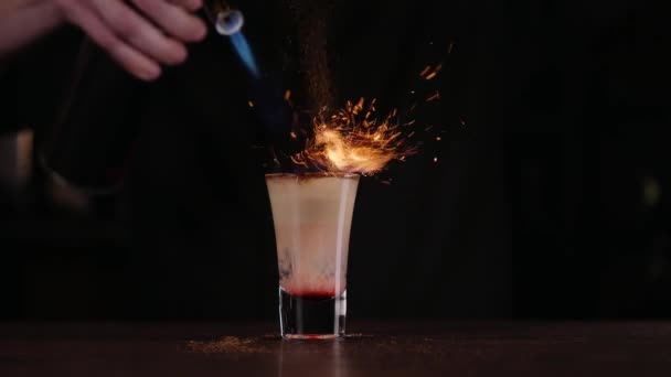 O barman faz um cocktail de fogo. Cocktail de Hiroshima. O barman acende o isqueiro no bar — Vídeo de Stock