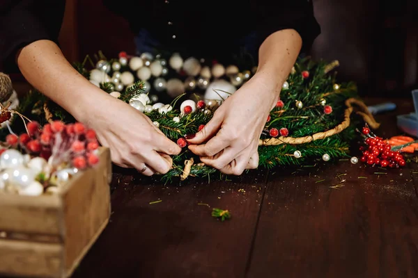 Sevimli genç gülümseyen kadın Tasarımcısı Noel yaprak dökmeyen ağaç çelenk hazırlanıyor. Noel dekor kendi elleriyle üreticisi. Tatil için Noel çelenk. Yeni yıl kutlama. Portre