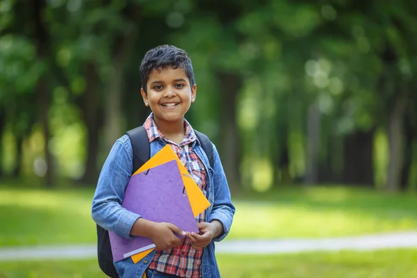 Outdoor portrait afro american happy school boy with books and backpack. Young student beginning of class after vacation. Back to school concept. — Stock Photo, Image