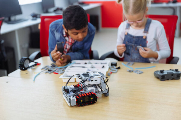 Mixed Racial group of School kids sitting at class with diy robot, stem education concept.