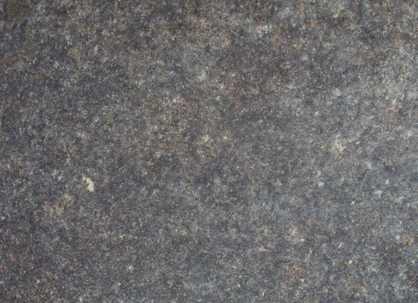 Bakgrund av mörk sten med flerfärgade stänk. Naturlig konsistens — Stockfoto