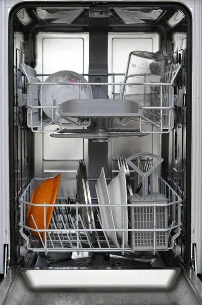 kitchen dishwasher with dirty dishes inside ready to wash