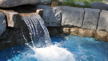 Bahçe ve çevre düzenlemesi. yapay şelale ev çim üzerinde. Bahar