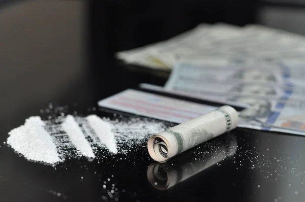 Cocaine divided into paths on a black background — Stock Photo, Image