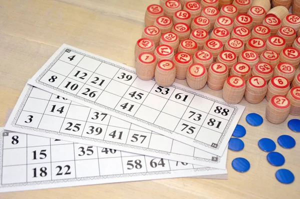 Wooden kegs, cards and chips for a game in a lotto.