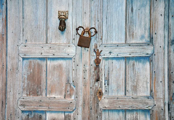 Background of vintage blue door with lock and handle.