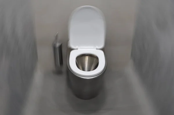 Modern stainless steel toilet in the toilet room. Radial blur — Stock Photo, Image