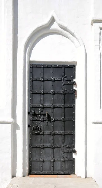 Ancient gate. Old metal black gate. Old vintage front door. Historical landmarks.