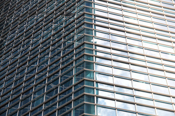 Skyscraper facade with glass facade and reflections. Modern architecture