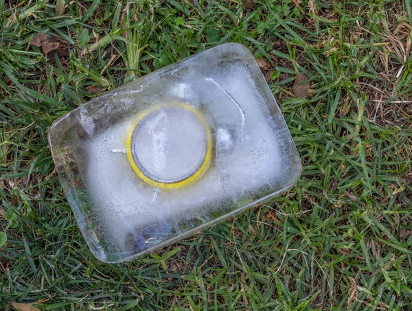 Retro yellow alarm clock frozen in a block of ice image with copy space