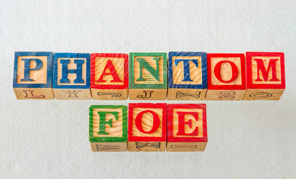 The term phantom foe visually displayed using colorful wooden blocks on a clear background image with copy space in landscape format