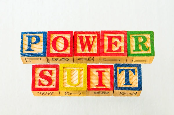 The term power suit visually displayed on a clear background using colorful wooden blocks image in landscape format with copy space