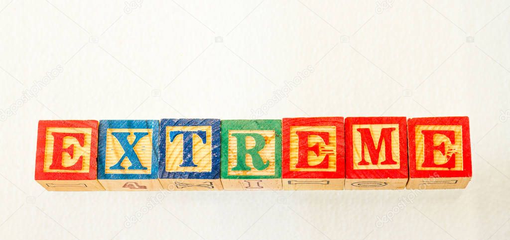 The term extreme visually displayed on a clear background using colorful wooden toy blocks image in landscape format