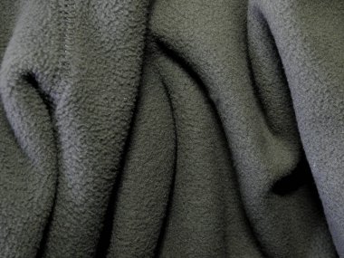 Kabarık yün kumaştan yapılmış battaniye. Arka plan yumuşak pelüş kumaştan yapılmış ve katlanmış.