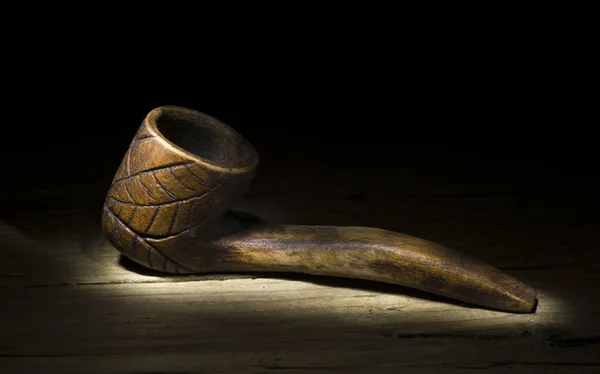 Sculpture of a pipe in handmade wood