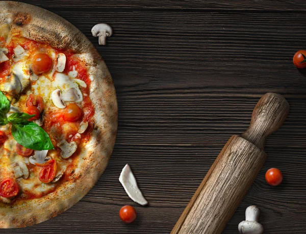 Pizza with fresh mushrooms cherry tomatoes and mozzarella on rustic wooden table — Stock Photo, Image