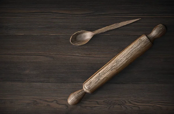 Old wooden spoon and rolling pin on rustic wooden table — Stock Photo, Image