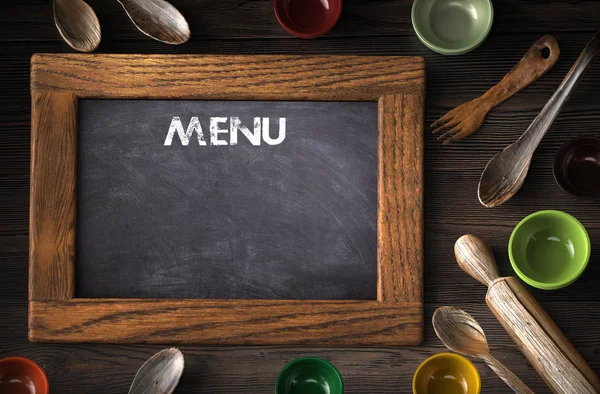 Rustic wooden kitchen utensils and blackboard with menu writing — Stock Photo, Image