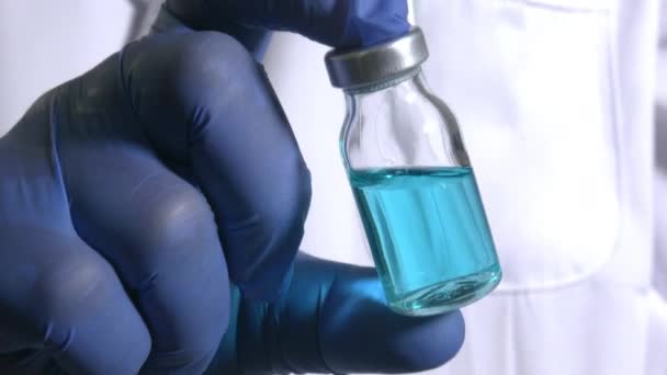 Analyst Arzt Mit Einem Glasfläschchen Mit Blauer Flüssigkeit Impfstoff Experiment — Stockvideo