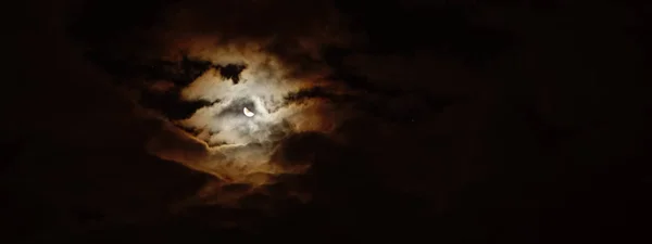 Night sky background. Moon and night sky with clouds.