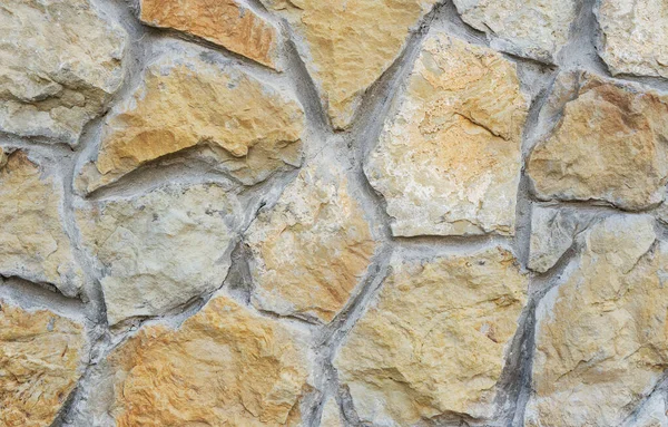 Struttura della parete di pietra. Parete di ciottoli naturale come sfondo . — Foto Stock