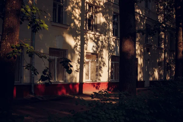 Shadows from trees on the facade of the house. Architecture in the Old Town area in Obninsk, Russia