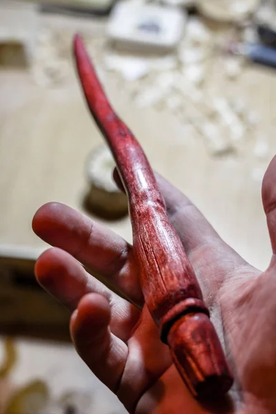 Wooden magic wand in hand, hand-crafted
