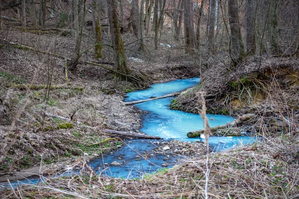 Painted in a bright blue river after illegal discharge of polluting liquid