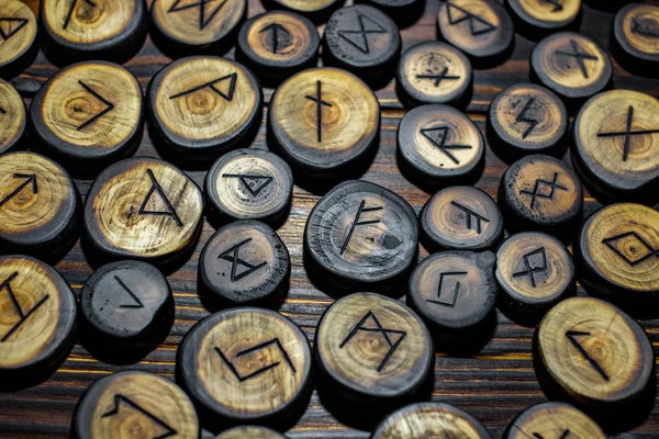 Runes carved from wood on the vintage table