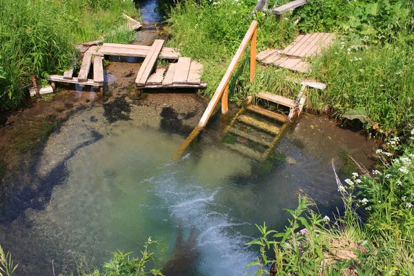 Bath in cold spring water near the monastery. Borovsky District, Russia