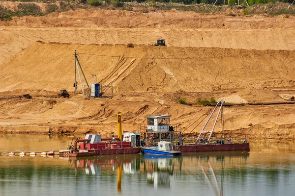 Dredger floating in the middle of a sand pit, mining of non-metallic minerals