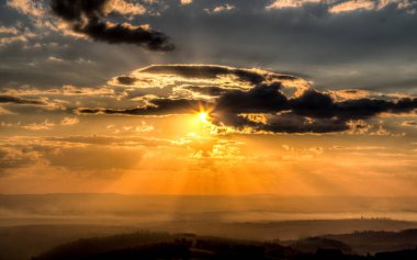 Bir bulutlu gün batımı dağ