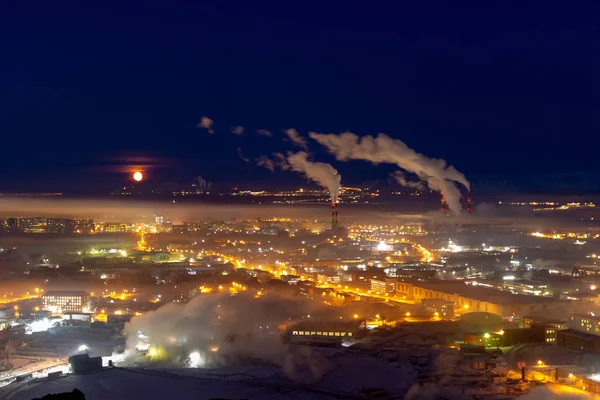 Moon over night industrial city, November 26, 2018, Norilsk