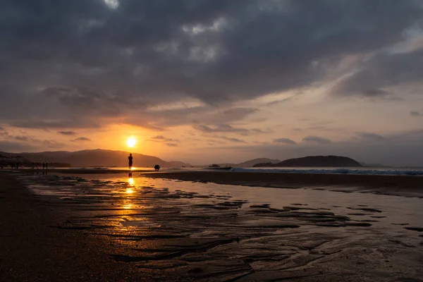 Silhouettes of people on the background of a golden dawn on the