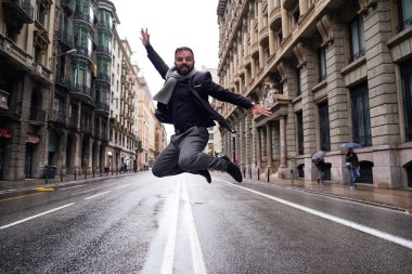 genç bir adam Via Laietana, Barselona, bir kış ve yağmurlu bir günde atlar