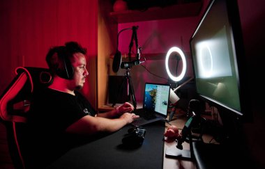a gamer playing and streaming live with microphones and cameras clipart