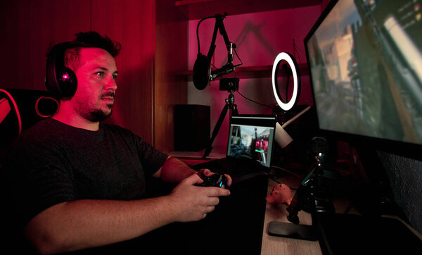 a gamer playing and streaming live with microphones and cameras