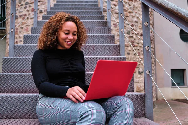 young afro american woman using computer oudoors