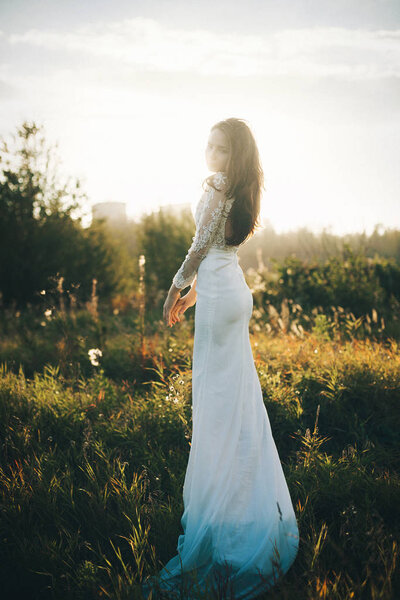 Romantic girl in the field. beautiful white dress
