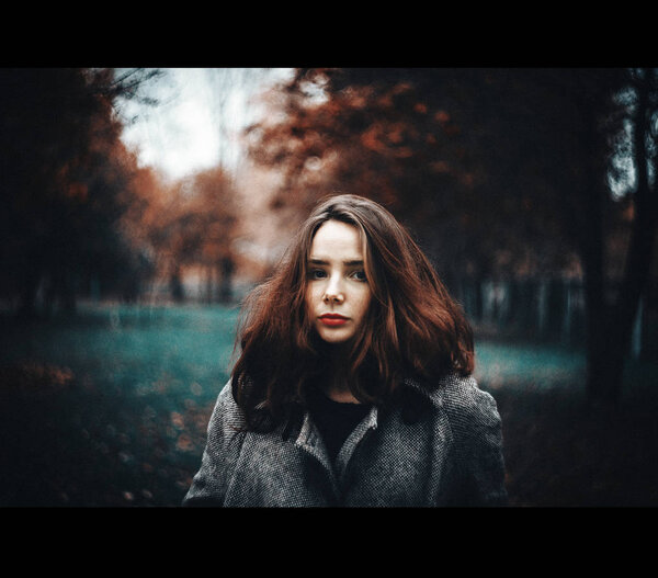 Beautiful girl in the autumn forest.