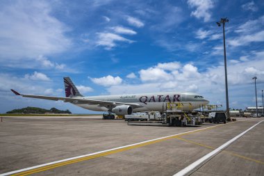 MAHE, SEYCHELLES - OCTOBER 4, 2018: Qatar Airways Plane at Mahe airport in Seychelles. Qatar Airways is included in the list of seven airlines with the highest five-star rating under the version of the British agency Skytrax. clipart