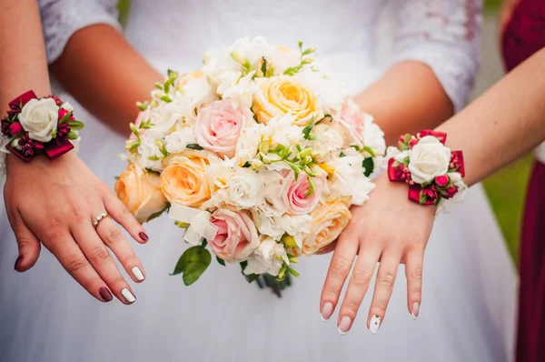 Wedding bouquet and hands