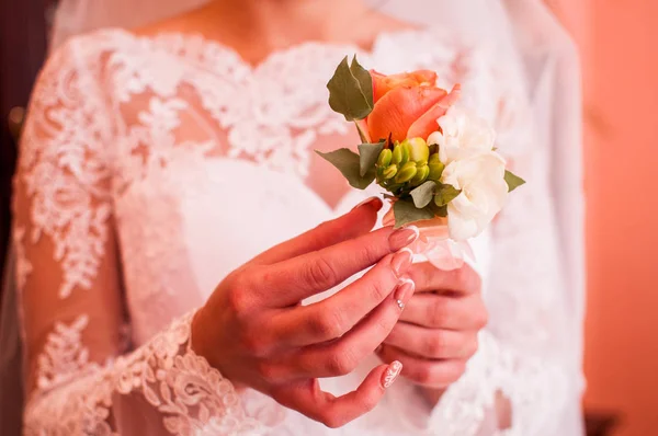 Bride holding rose in the hands