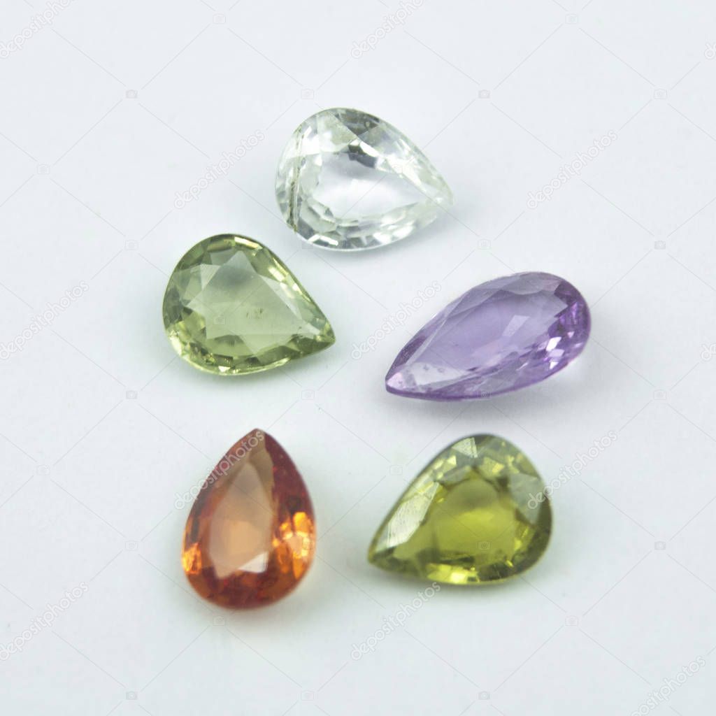 Colorfull natural sapphires in pear shape on the white background