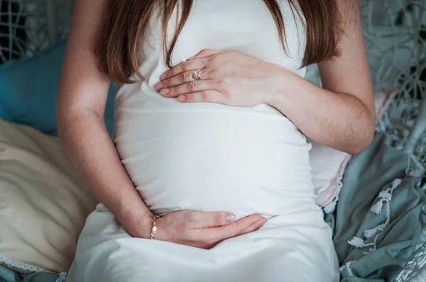 Pregnant woman in white dress and man hug belly — Stock Photo, Image